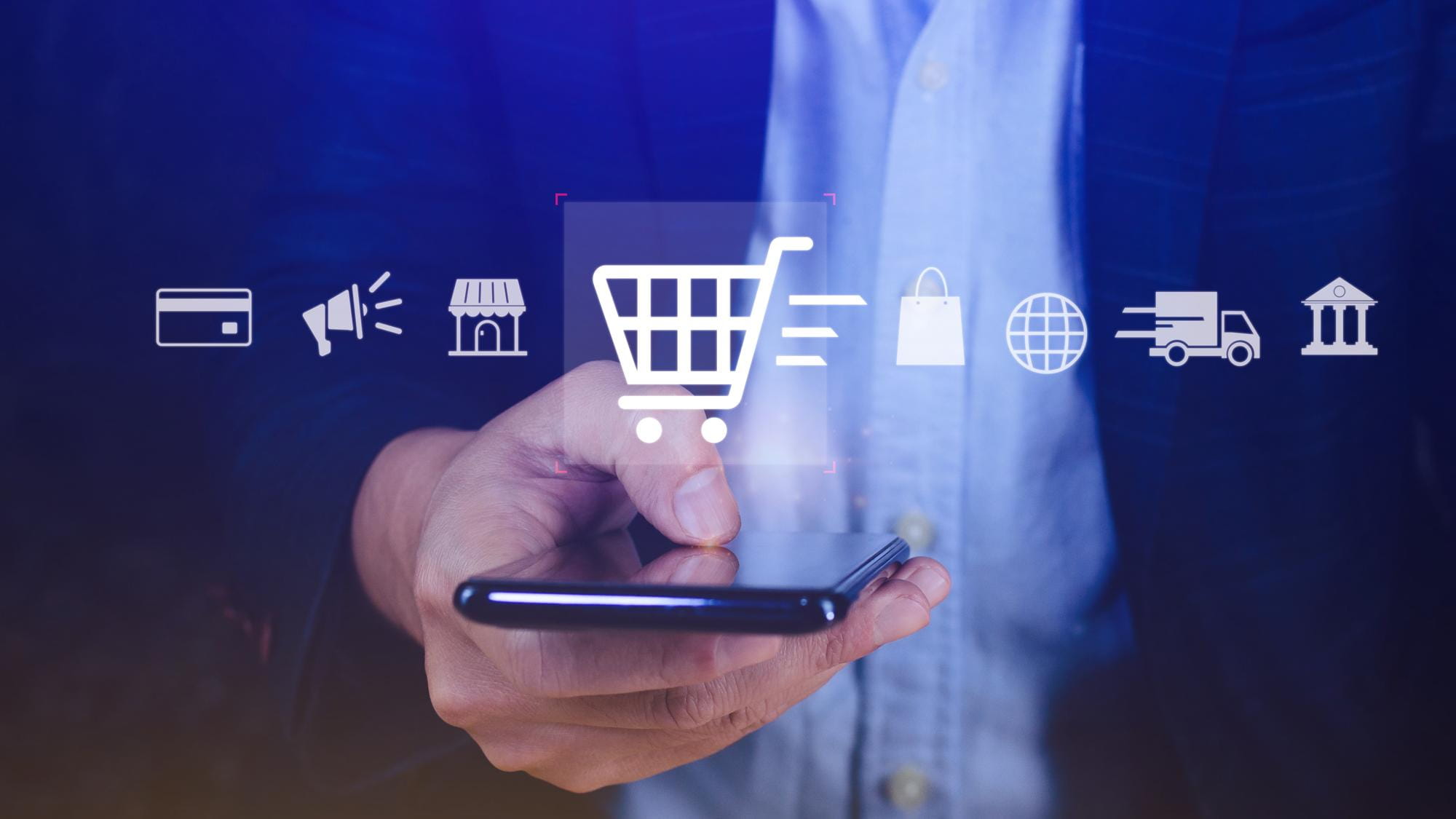 Person holding a phone with e-commerce icons overlaid for cart, payment, delivery and marketing